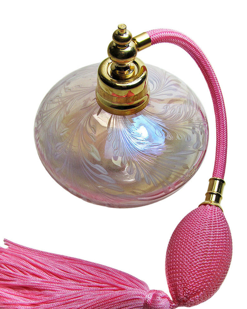 Decorative bottle with pink tassel on a white background