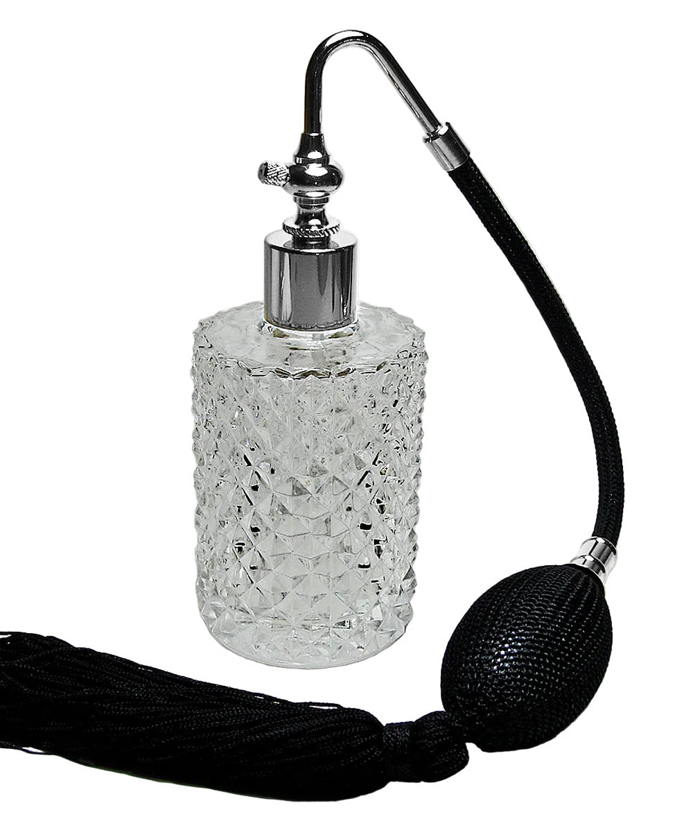 Decorative glass perfume bottle with a long black rubber hose on a white background