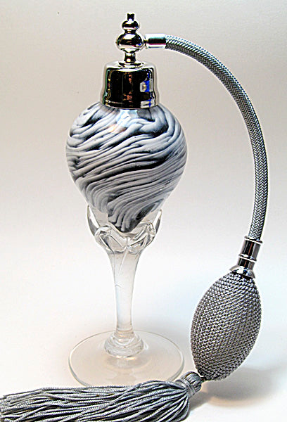 Art made with hand perfume bottle with silver gray bulb and tassel spray mounting.