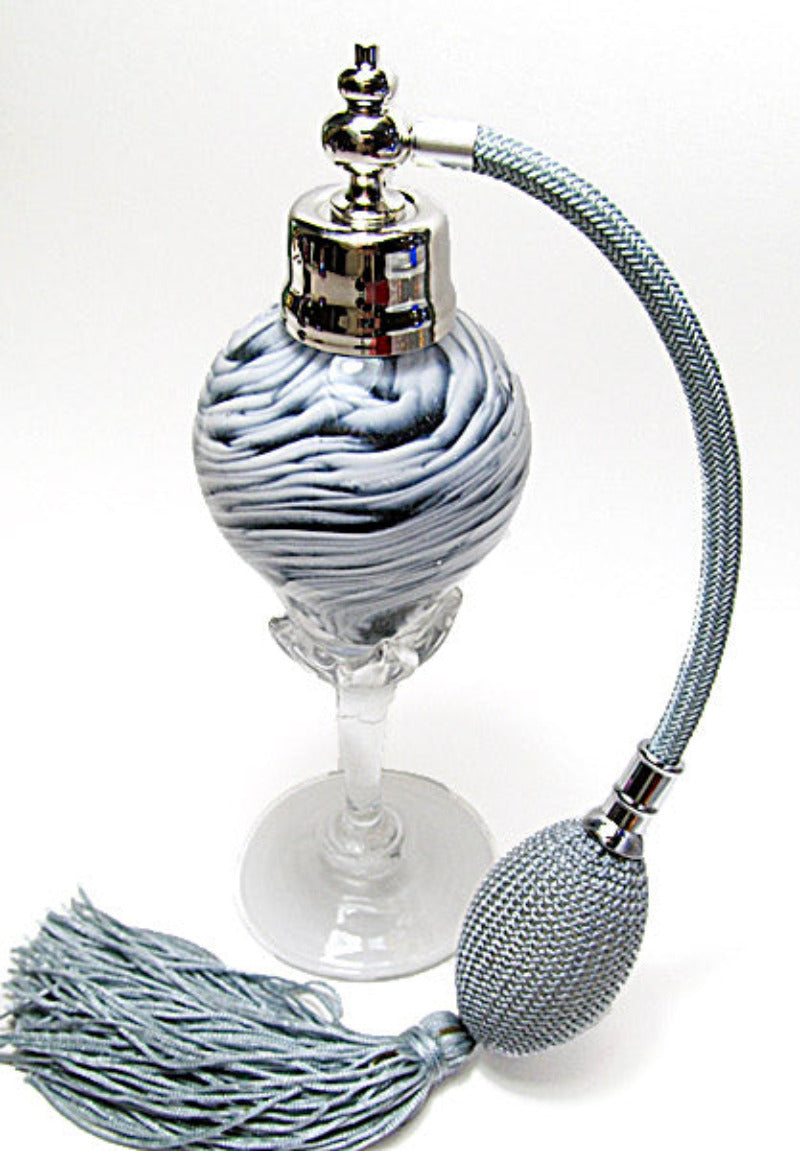 Art made with hand perfume bottle with silver gray bulb and tassel spray mounting.