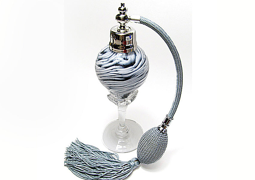 Art made with hand perfume bottle with silver gray bulb and tassel spray mounting.