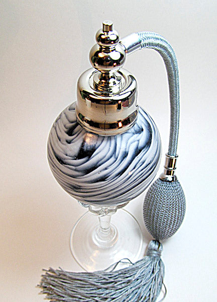 Art made with hand perfume bottle with silver gray bulb and tassel spray mounting.