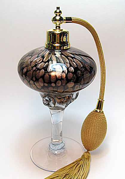 Art refillable perfume bottle with gold bulb and tassel spray mounting.
