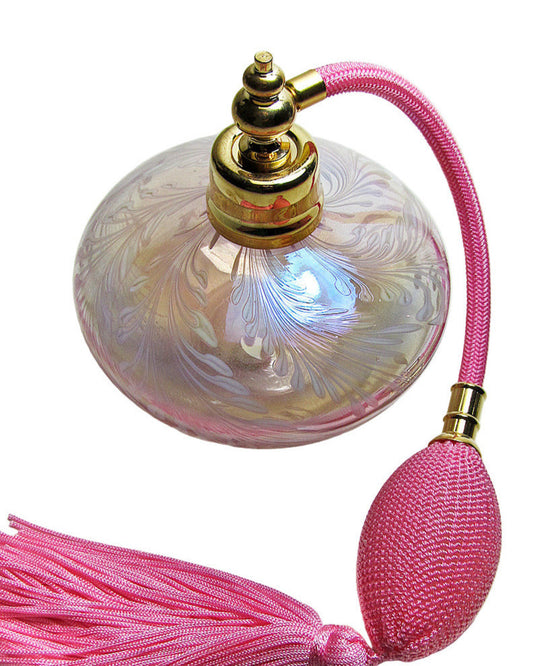 Decorative bottle with pink tassel on a white background