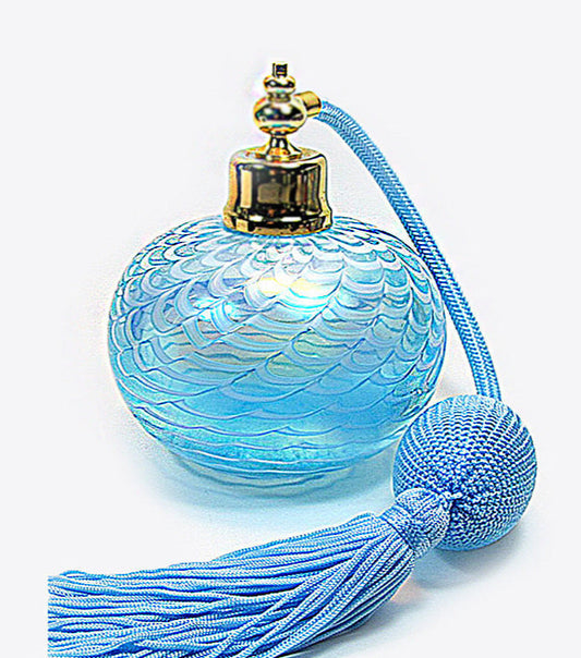 Art refillable crystal glass perfume bottle with light cyan tassel spray attachment.