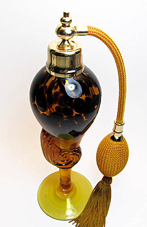 Art crystal glass perfume bottle with brown gold bulb and tassel spray mounting.