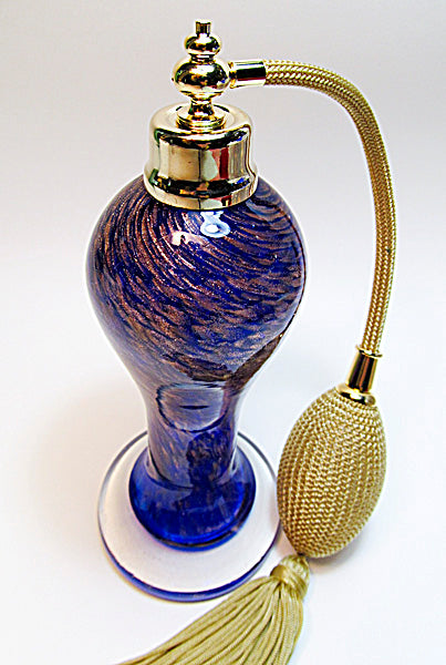 Art made with hand perfume bottle with gold bulb and tassel spray mounting.