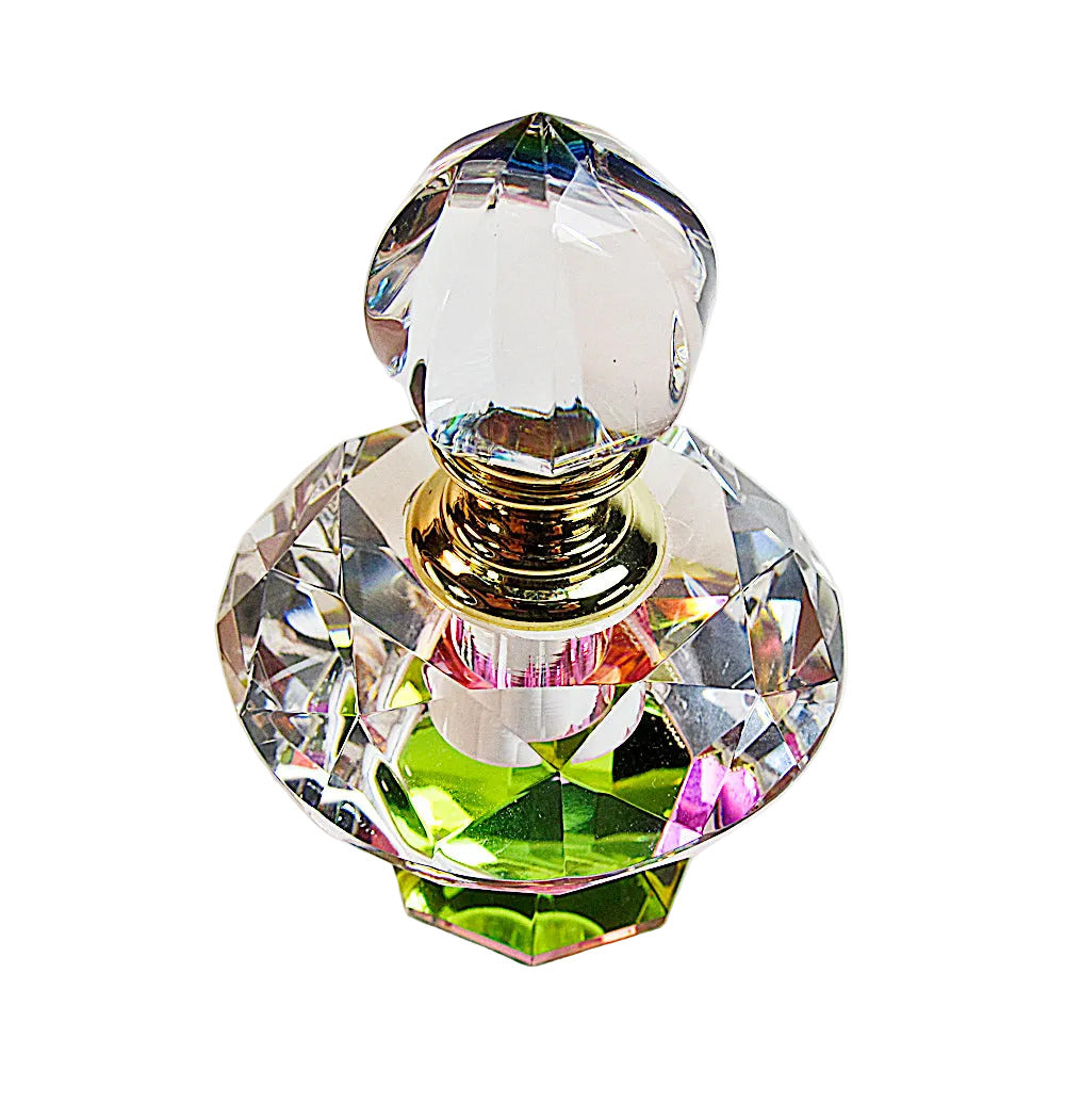 A clear faceted glass perfume bottle with a gold neck and a rounded crystal stopper, photographed on a plain white background.