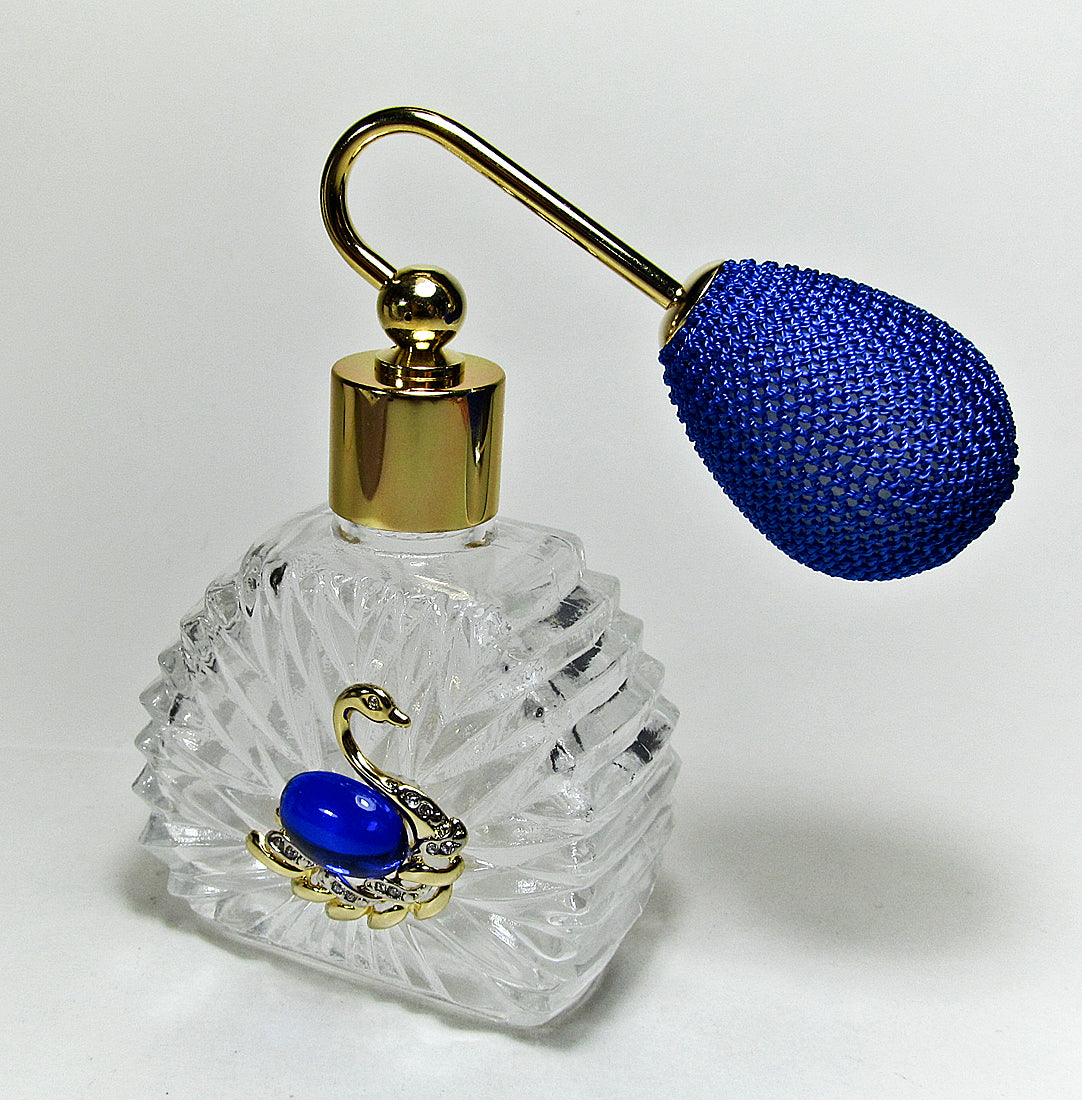 Unique vintage perfume spray bottle with blue bulb spray attachment.